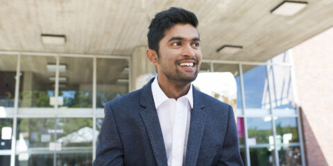 Curtin student dressed up in smart business suit looking confident.