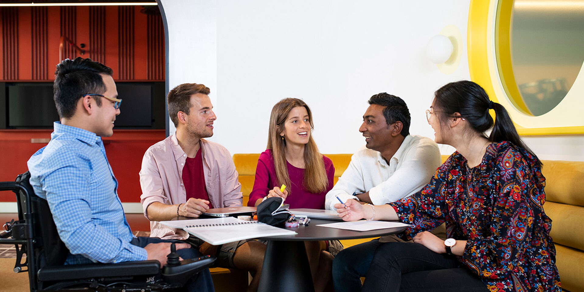 Five students sitting in a classroom