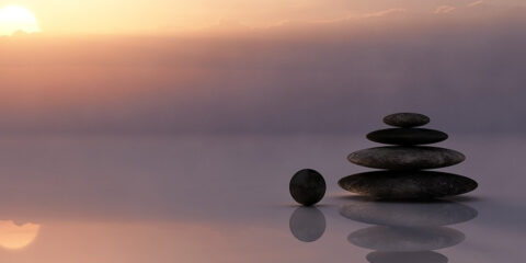 Sunset with a stack of rocks in the foreground