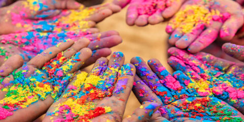 Hands in a circle covered in paint