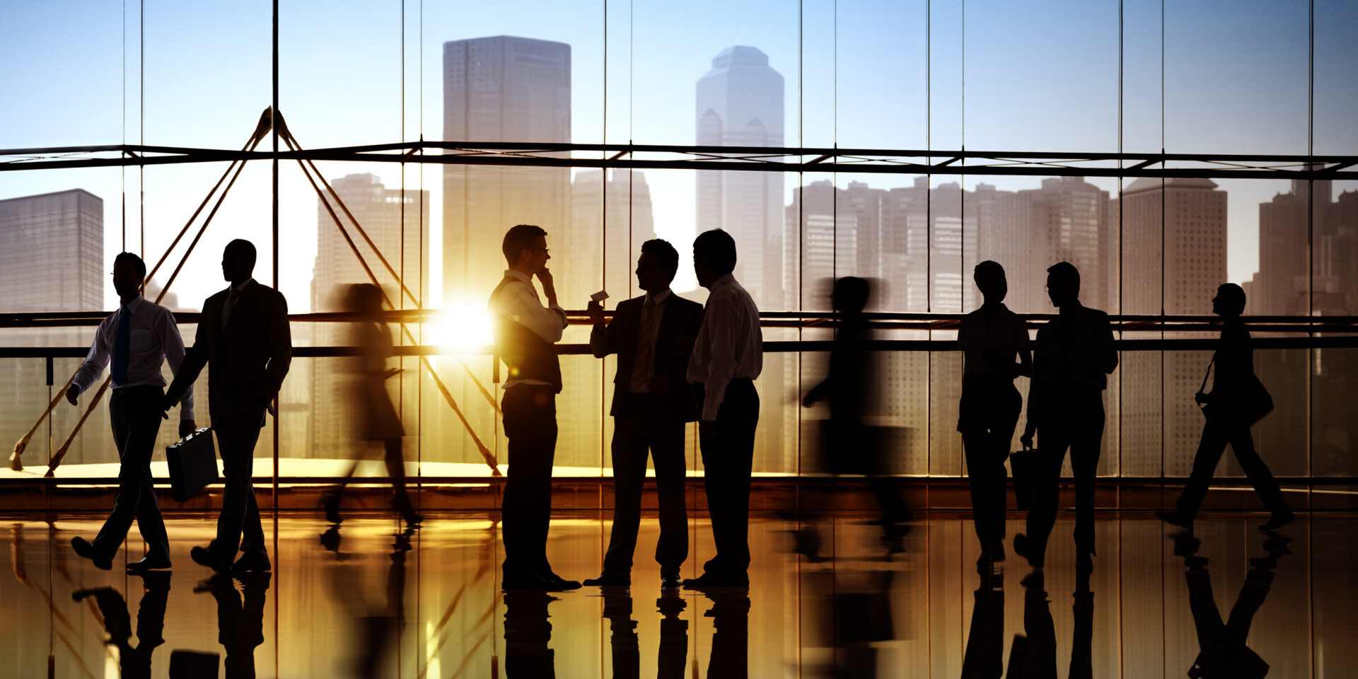 A group of people talking in a business building.