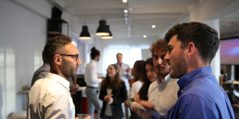 Group of people speaking at a networking event.