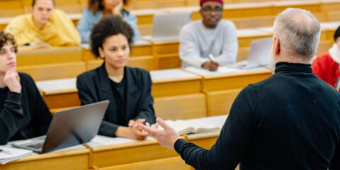 Lecturer giving a presentation to a group of students.