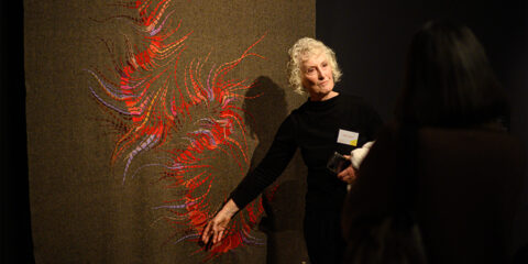 Artist Helen Seiver in conversation with her artwork The Nullagine River.