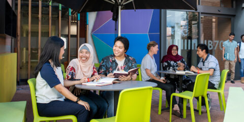 Three students sitting outdoors at Curtin Kalgoorlie.