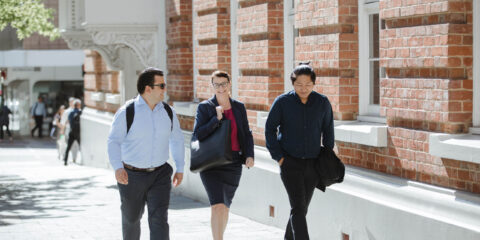 3 MBA students walking on Curtin's city campus.