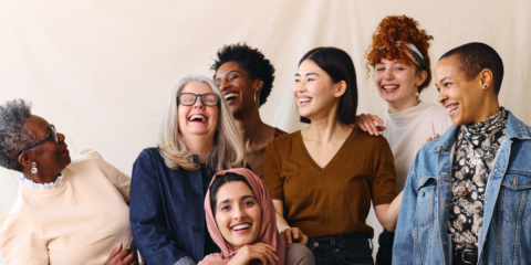 A group of diverse women laughing and smiling