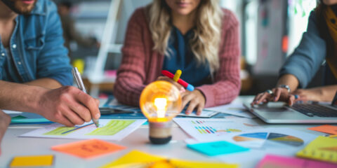 Students coming up with ideas on a sticky note