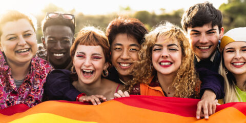 A diverse range of people smiling at the camera.