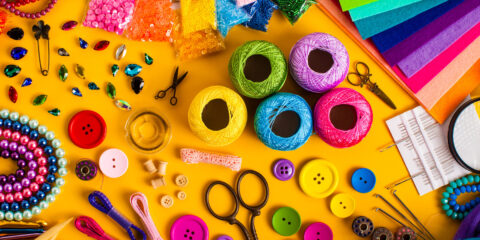 Craft supplies on a yellow background.