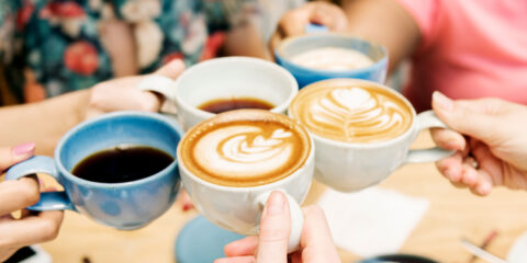 Coffees being held by people.