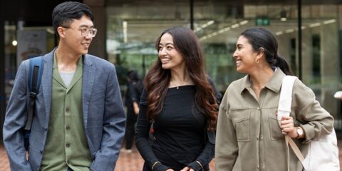 A group of mature age students chat outside the Curtin library