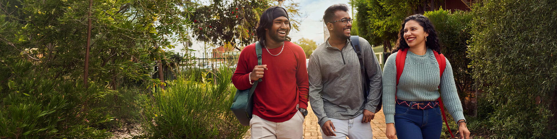 Three students chat as they walk across the Curtin Kalgoorlie campus