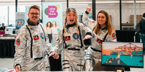 Three people wearing astronaut outfits.