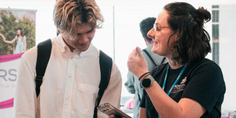 Two people talking at a Jobs Fair.