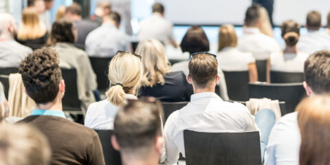 People sitting in chairs in a conference room.